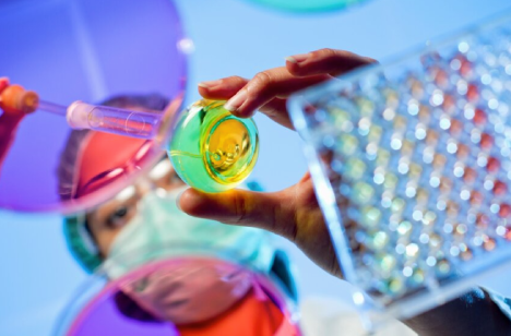 scientist putting something in a test tube